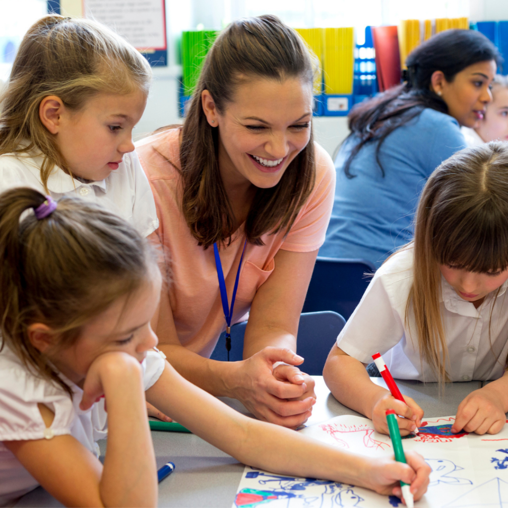 Teaching Assistant Female with 3 young children in classroom