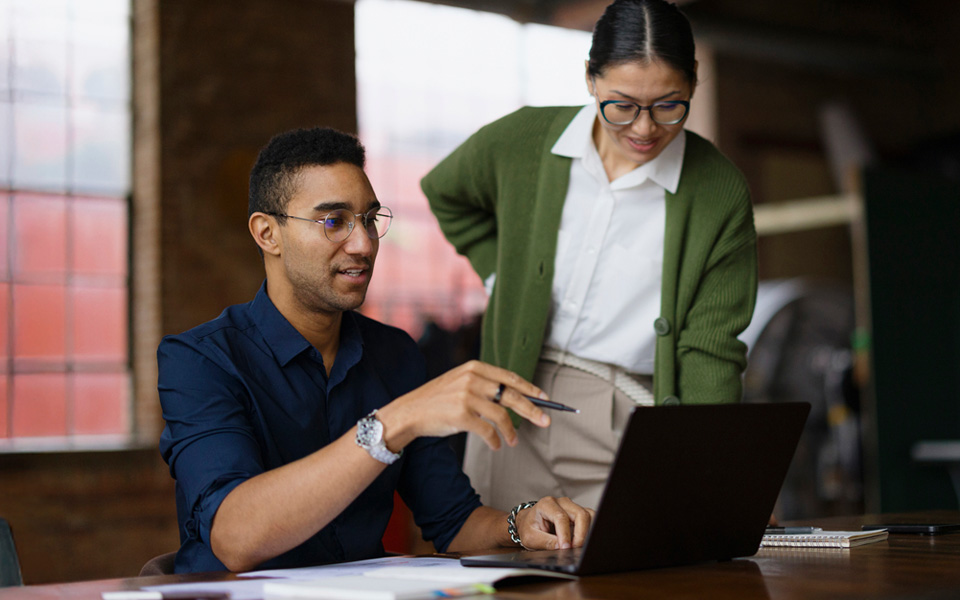 Male and female workers in discussion in office environment