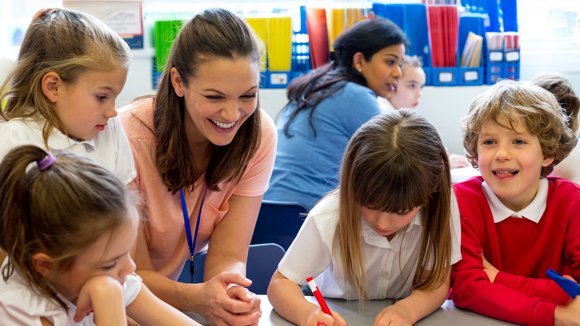 Teaching assistant working with primary school children