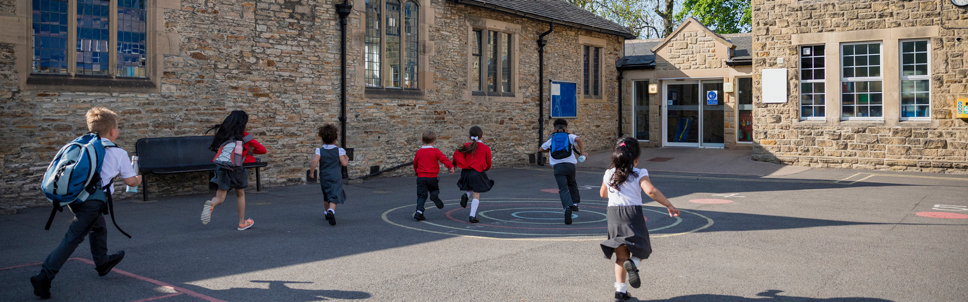 Primary school children running into UK school