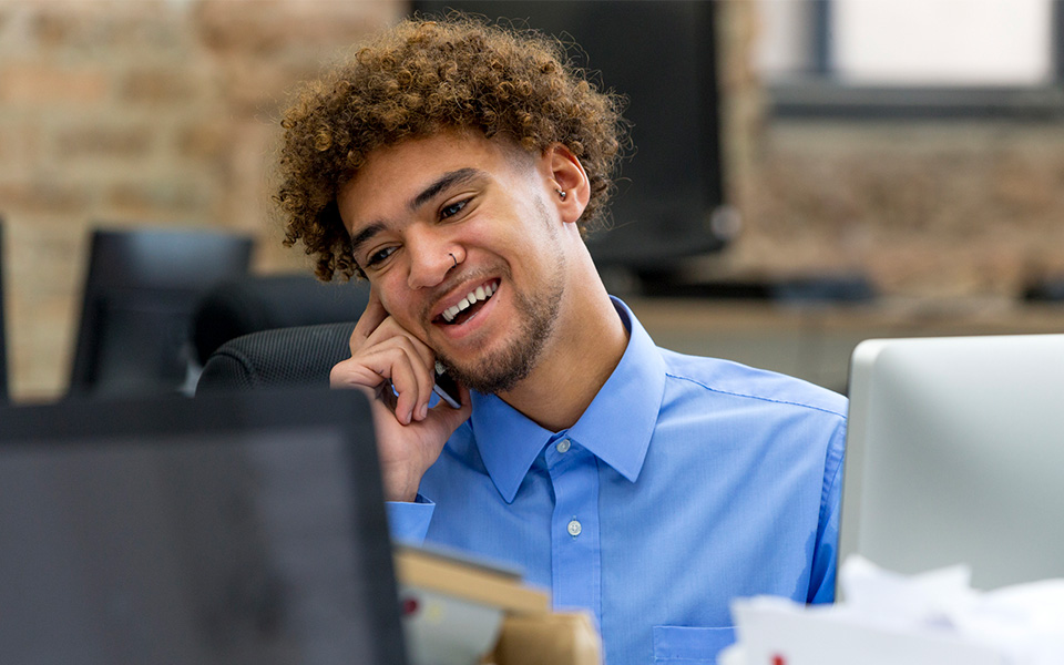 Male on telephone in office environment