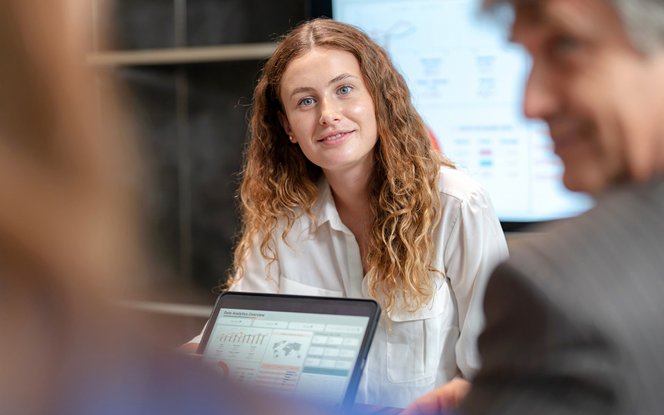 Female employee listening during a meeting regarding data