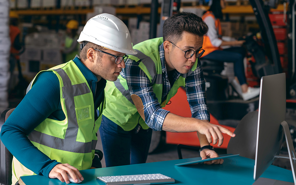 Warehouse operative discussing operations with their line manager