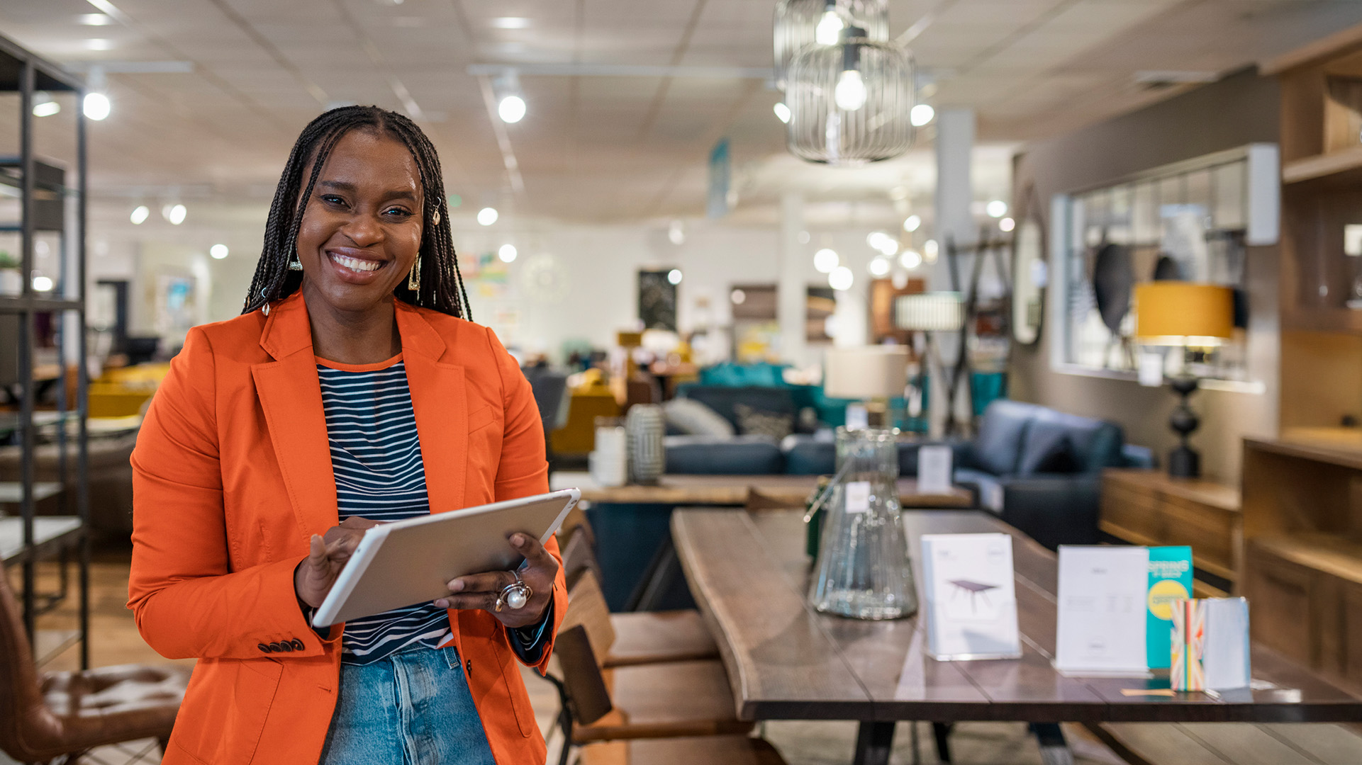 Female retail team leader looking directly at camera smiling