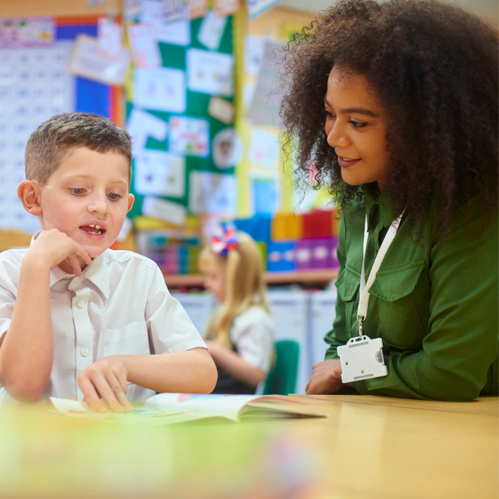 Female teacher with young child in classroom