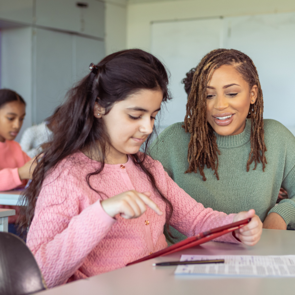 Female teaching assistant with pupil