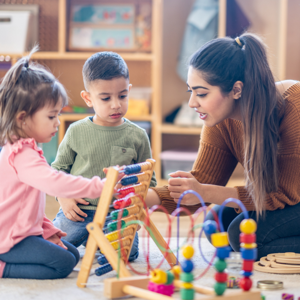 Female in nursery setting with 2 young children