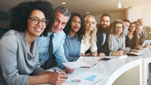 Team of people in office sat at desk