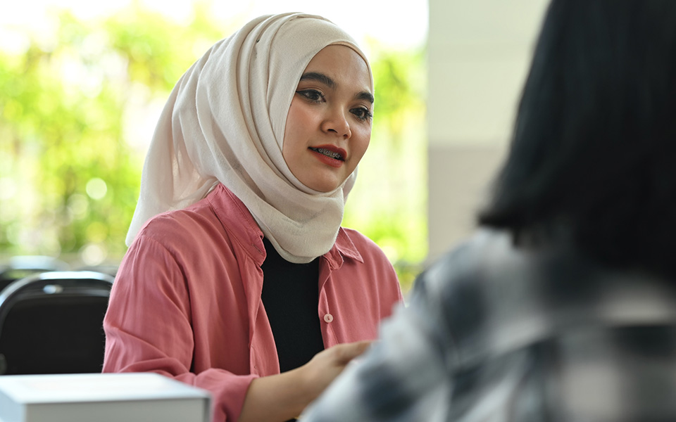 Female employee actively listening to a colleague