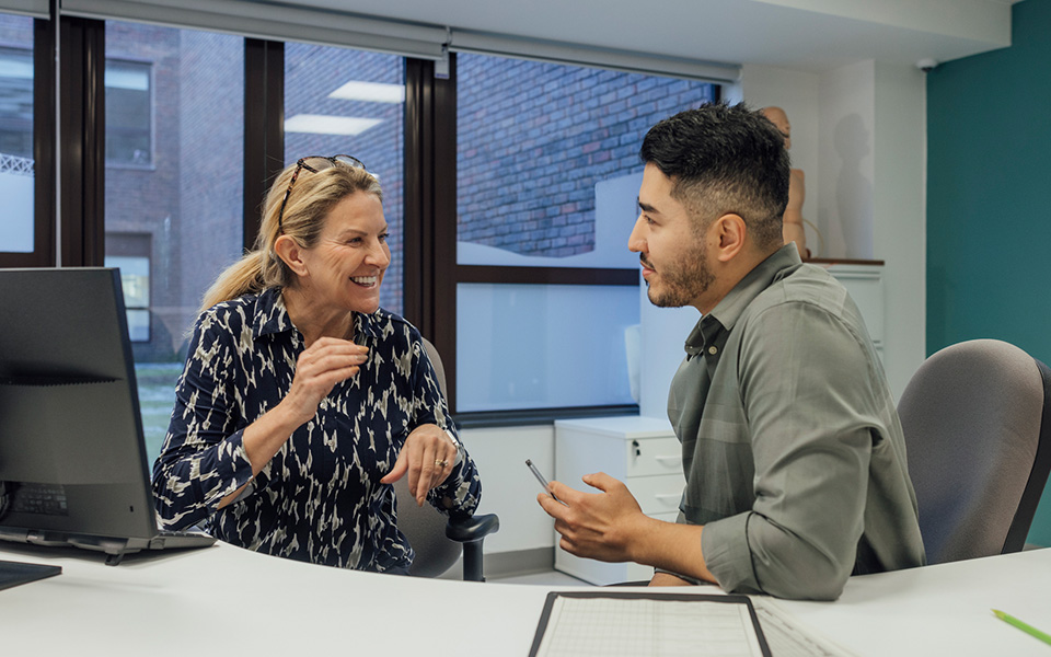 Male and female colleagues in discussion in hospital office setting