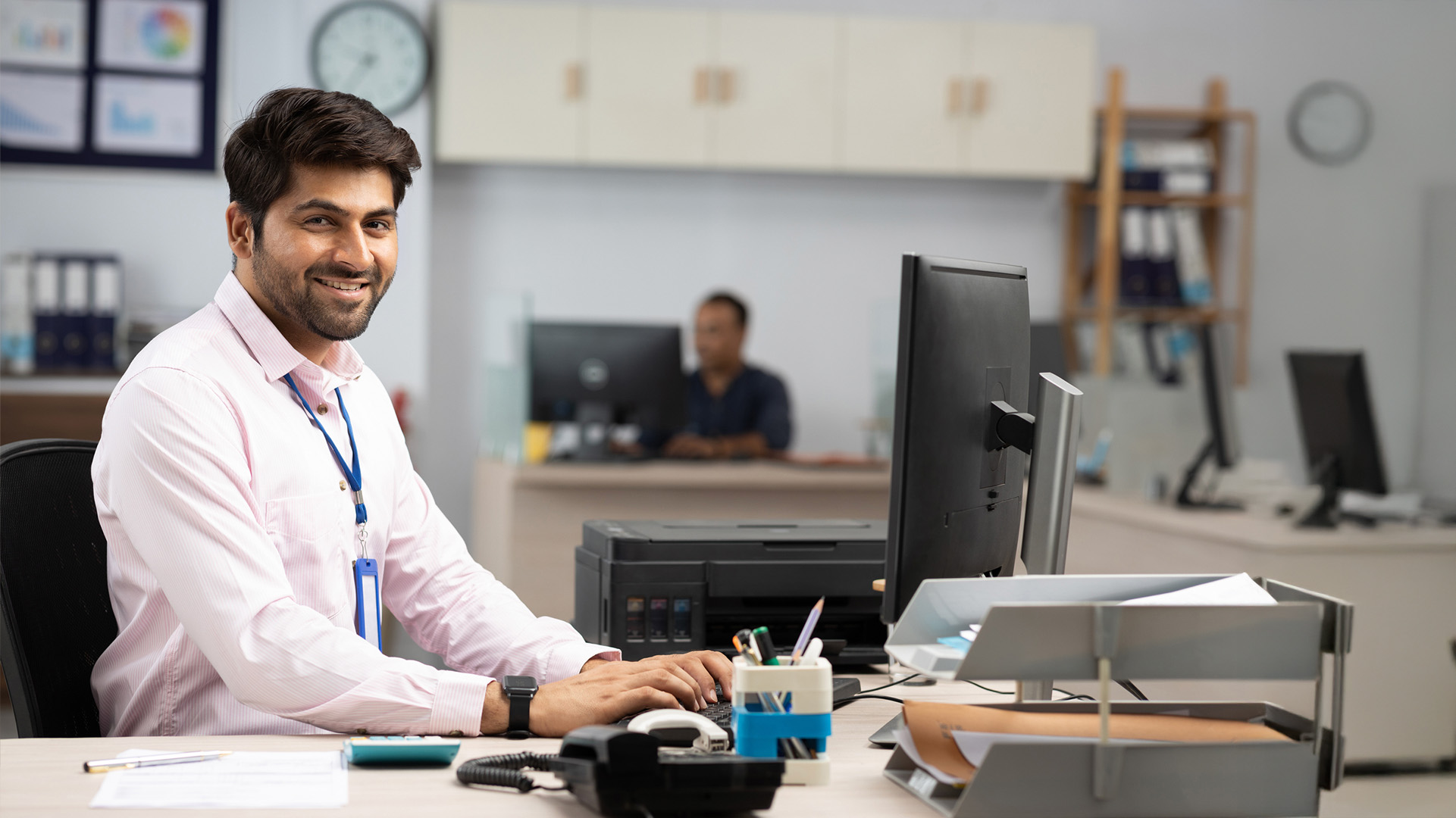 Male medical administrator working on a computer in an office