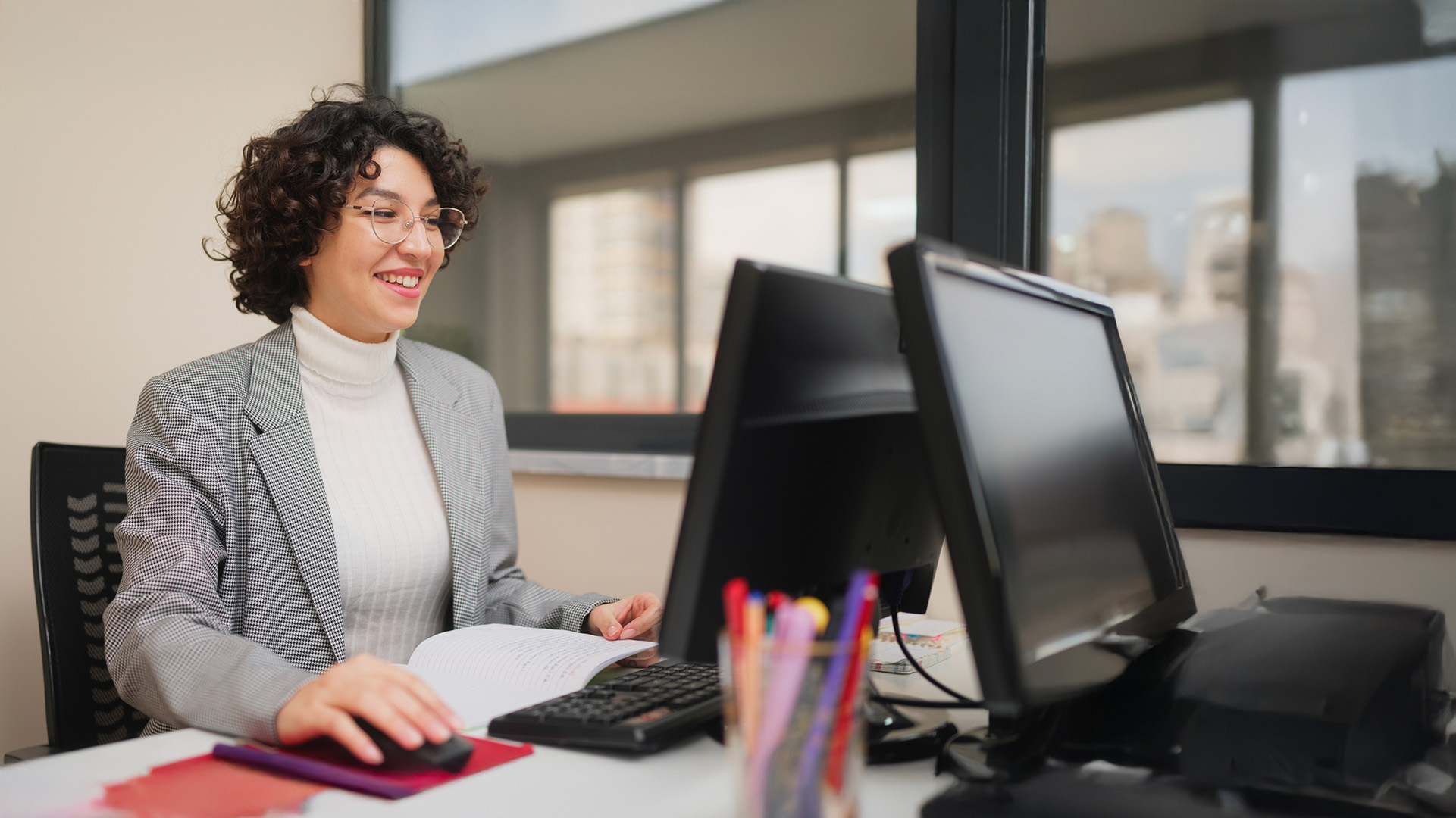 Female teacher working on a computer in an office enviroment