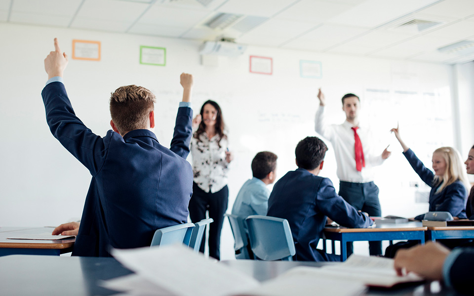 High school classroom with teacher and teaching assistant working together