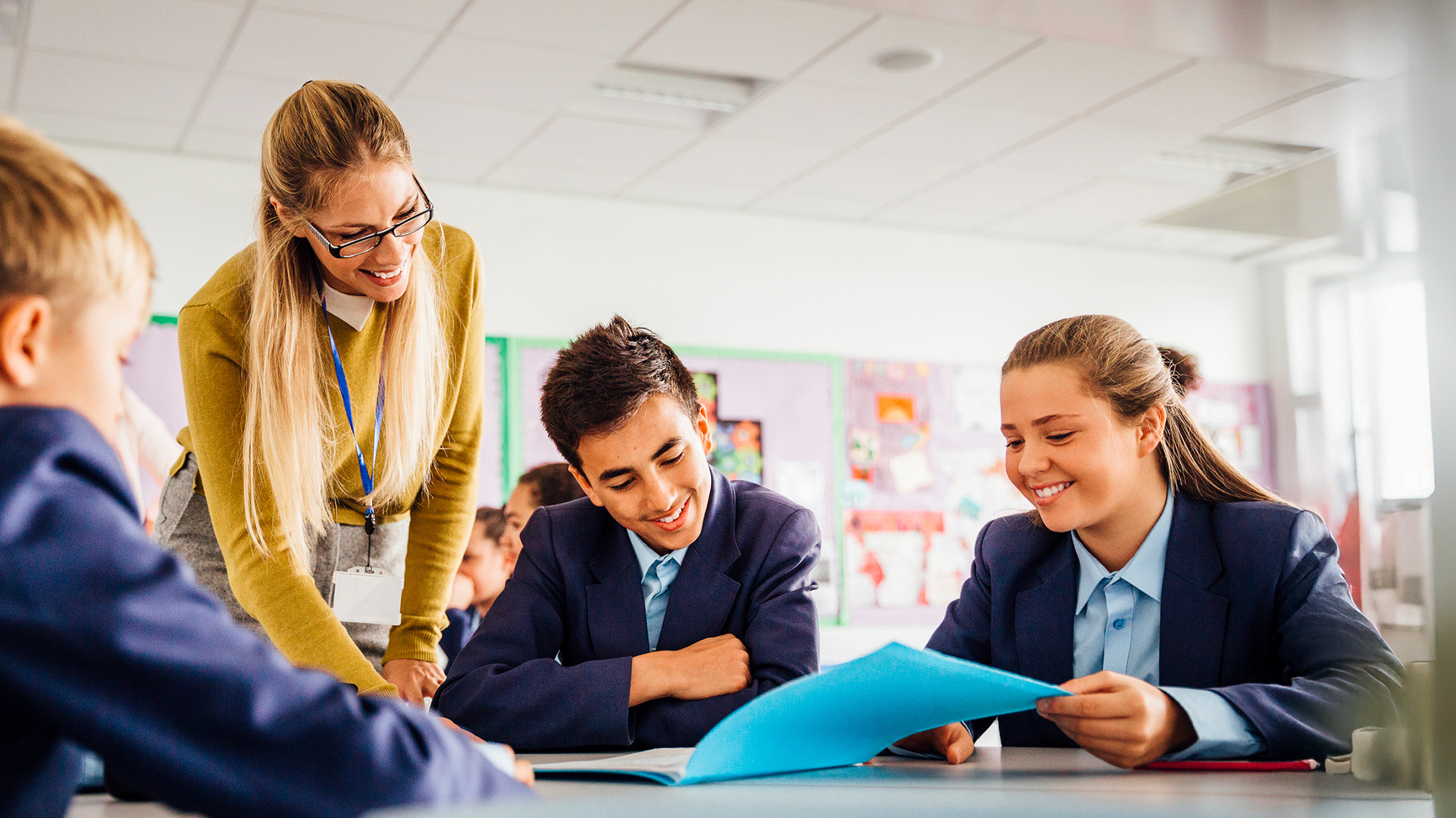 Female teacher working with students in a high school