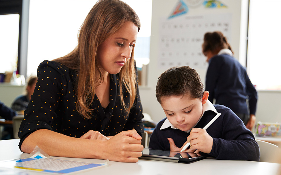 Female teaching assistant with SEN student