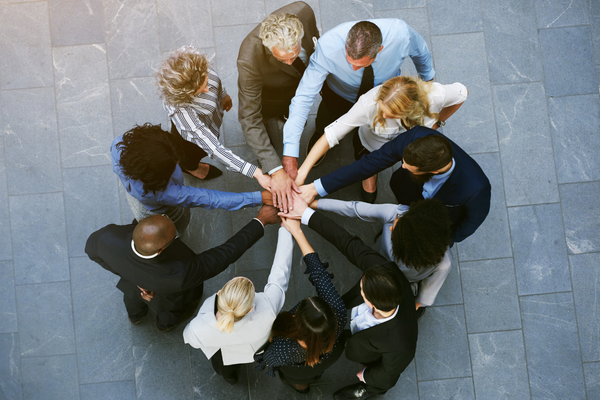 Group of people showing support with hands together